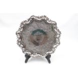 18thC Irish Silver Salver with chaised decoration and scroll rim supported on 3 pad feet 10'' in