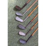 Six wooden shafted golf clubs including H.J. Osborne, J. Sherlock, Lillywhites, Niblick (Glasgow