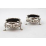 Pair of Mid Victorian Silver Floral ebossed Open salts supported on pad feet, By William Hunter,