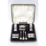 Cased Cruet Set with blue glass liners and matched spoons Birmingham 1947