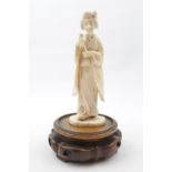 Late 19thC Japanese Ivory figure of Geisha with wooden carved base, 15cm in height