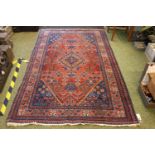 Early 20thC Turkish Red and Blue ground rug with central medallion 210 x 133cm