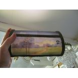 An unusual glass light shade for a desk light with landscape scene