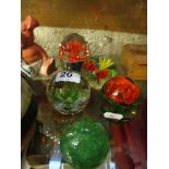 Four floral paperweights and a green bubble glass paperweight