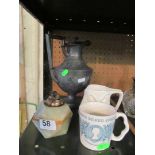 A Masons silver jubilee mug, double face mug, plated water jug and onyx lighter