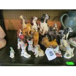 A Royal Doulton dog holding a pheasant and other dog ornaments