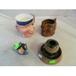 A Royal Doulton match striker, Beswick character jug 'Mr Wink' and two other character jugs