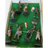 Seven Napoleonic French and British soldiers and a figure of Napoleon.