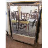 A large black and gilt framed mirror