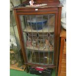 An Edwardian display cabinet.with single leaded glazed door.