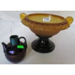 An amber glass bowl on stand and a lustre glass jug