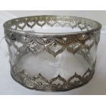 A glass bowl with white metal rim of arch design