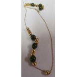 A 14k green stone necklace