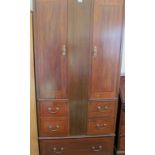 An Edwardian made up wardrobe with hidden compartment to centre