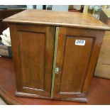 A small two door collector's cabinet with six drawers to interior