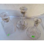 Three silver top decanters