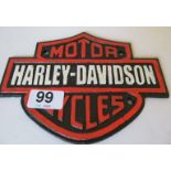 A metal Harley Davidson plaque.