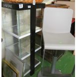 An Estee Lauder display cabinet and stool