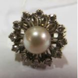 A 14K pearl and diamond cluster ring.