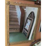 A gilt framed leaf design mirror.