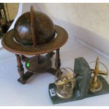 A pair of orb and arrow bookends and a modern globe