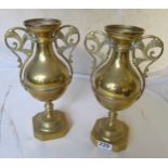 A pair of two handled brass vases