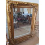 A large gilt ornate frame mirror