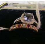 Two 9ct gold rings one eternity with red and clear stones and another purple stone