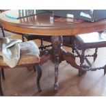 A circular mahogany table with inlaid top, pillar and quadruple base