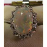 A 14k opal and diamond cluster ring.