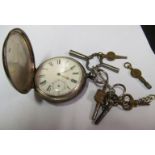 A silver pocketwatch and watch keys