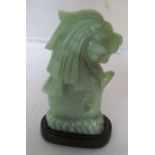 A jade Merlion on stand.