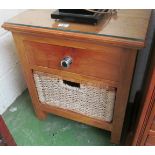 A bedside cabinet with glass top