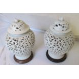 A pair of Oriental pierced lidded cream glazed vases flower and leaf design