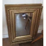 A gilt framed rectangular mirror of leaf design
