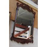 A walnut and gilt shaped framed mirror.