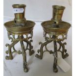 A pair of Gothic style brass candlesticks on paw feet