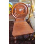 A Victorian oak hall chair with circular carved back