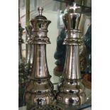 A pair of large plated chess pieces