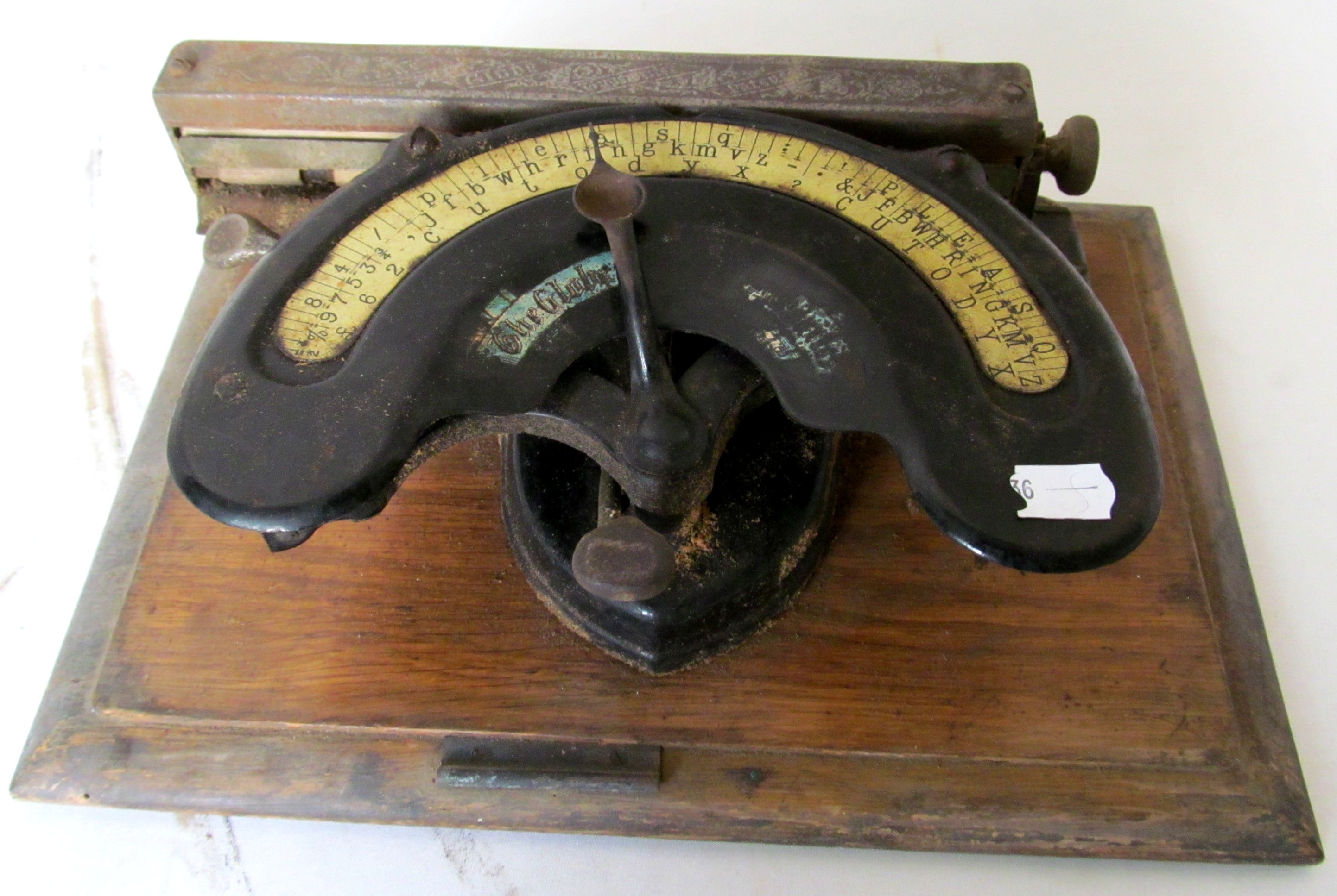 An American Globe typewriter in metal case (in need of restoration).