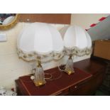 A pair of gilt and glass floral pattern table lamps with cream beaded tasselled shades