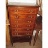 An Edwardian mahogany and satinwood banded chest of six drawers with under tier.