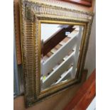 A gilt framed rectangular mirror