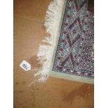 A green Bokhara rug