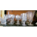 Six drinking glasses etched vine leaf design and a claret decanter and other drinking glasses.