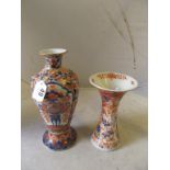 A Japanese Imari baluster vase (restored) and another Imari trumpet shaped vase (hairline crack)