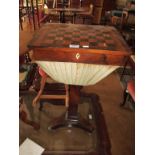A 19th Century satinwood and rosewood sewing/games table with chess board top and a basket under
