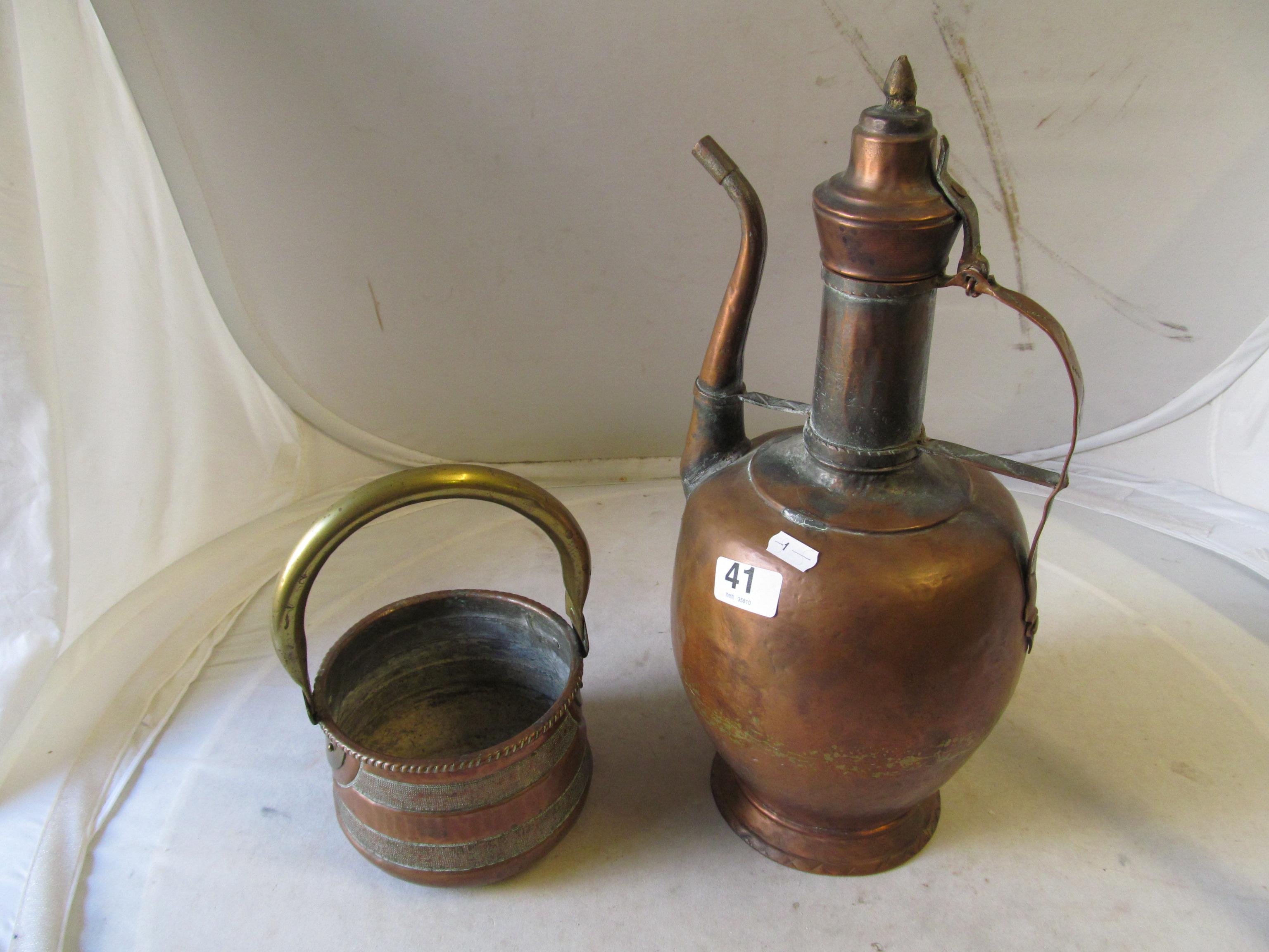 An eastern copper ewer and a brass and copper single handled bowl.