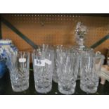 A cut glass decanter, another decanter and ten glass tumblers.