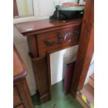 A mahogany finish fire surround with applied leaf scroll design